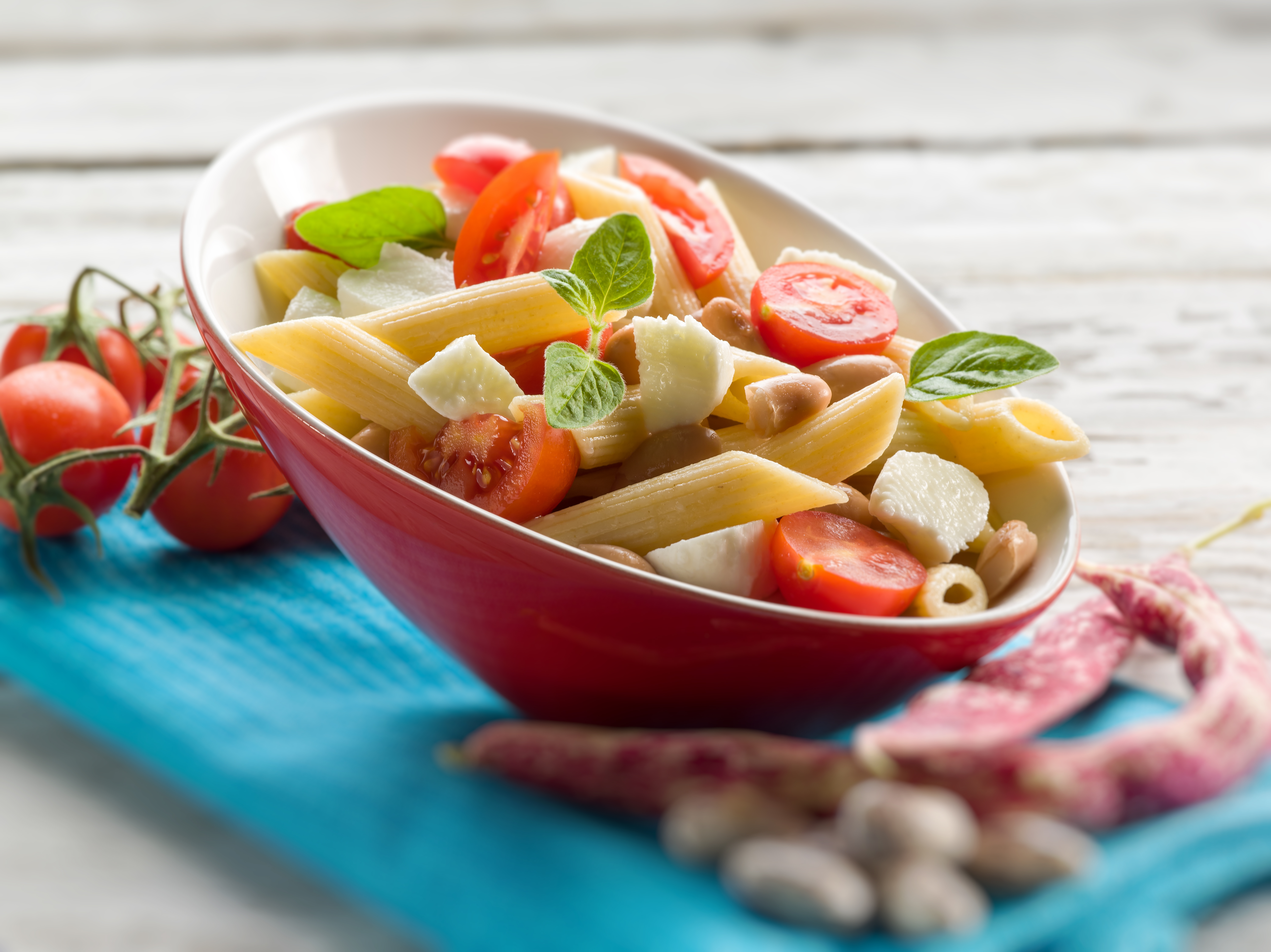 a healthy pasta salad with penne, tomatoes, mushrooms, and cheese