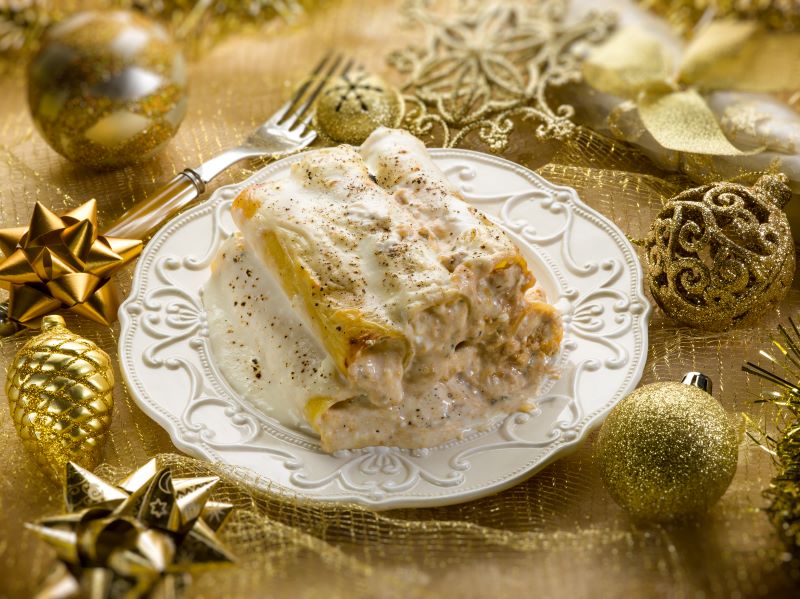 A creamy cannelloni on a golden Christmas table